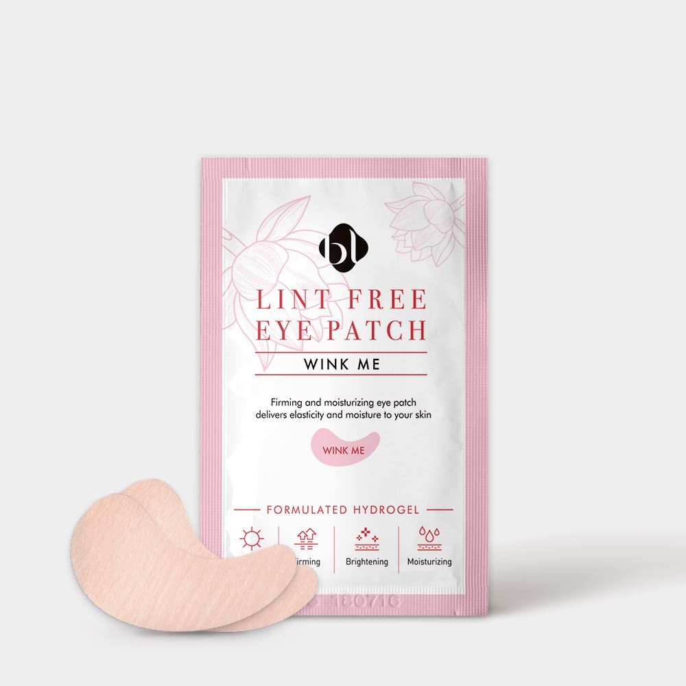 BL Lashes Lint Free Eye Patch “Wink Me” hydrogel eye patches in a pink and white sachet package displayed on a light gray background. The packaging reads “Lint Free Eye Patch Wink Me” and “Formulated Hydrogel,” with icons indicating firming, brightening, and moisturizing benefits. Two curved beige hydrogel patches are placed in front of the sachet, showing the shape designed to fit under the eyes during eyelash extension procedures or under-eye skincare treatments.
