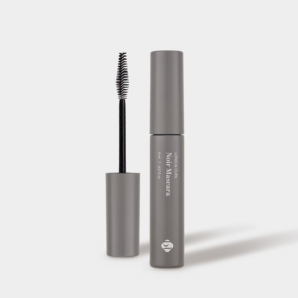 Front view of BL Lashes Noir Mascara tube next to its opened wand applicator.