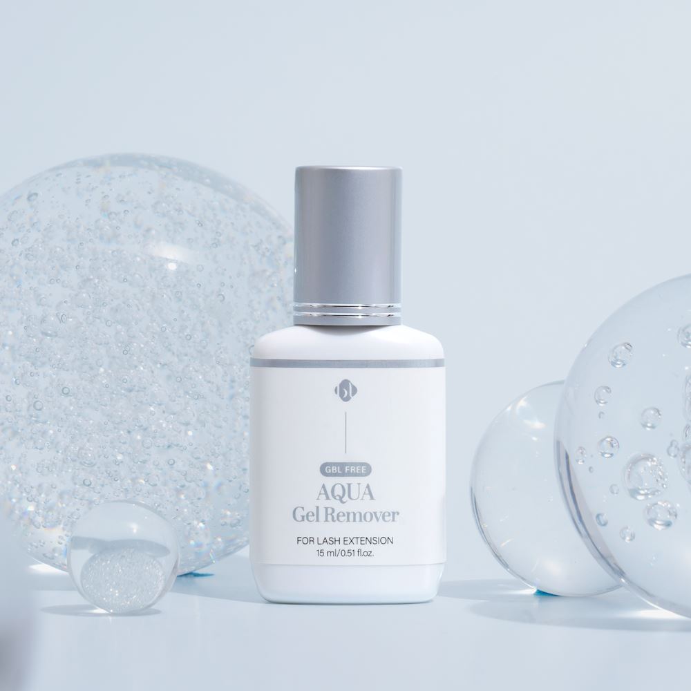 BL Lashes Aqua Gel Remover 15ml bottle with a silver cap displayed among clear, bubbly glass spheres against a light blue background.