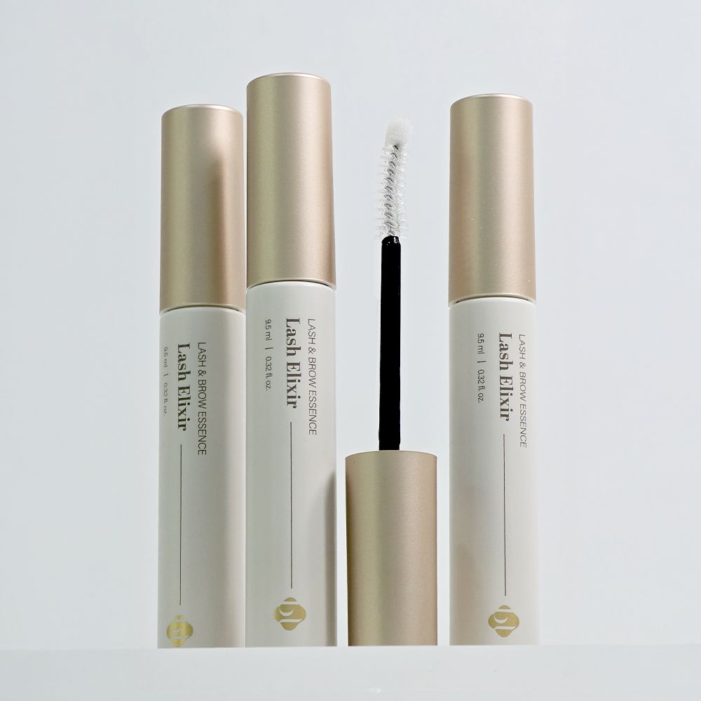 Group of three BL Lashes Lash Elixir tubes standing upright, with one opened wand applicator displayed in the center.